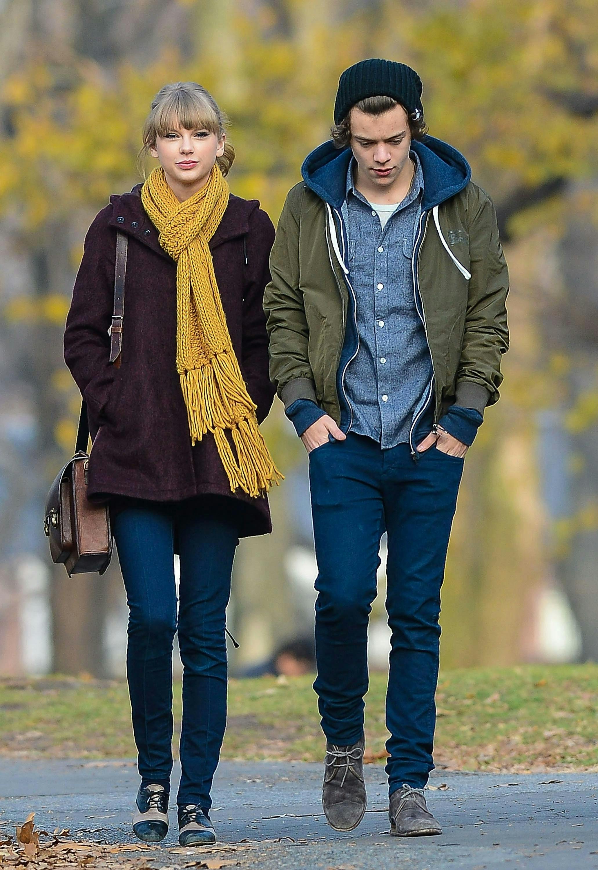 taylor swift and harry styles walking in a park