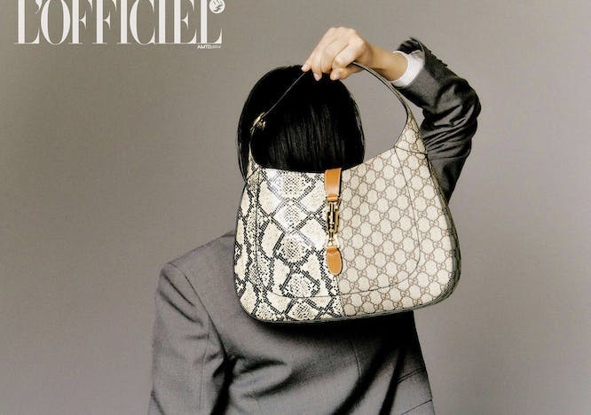 a model holding a gucci jackie bag