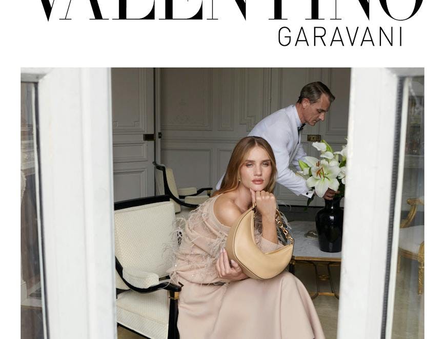 Rosie Huntington-Whiteley sitting in a nude colored flowy dress for a valentino campaign