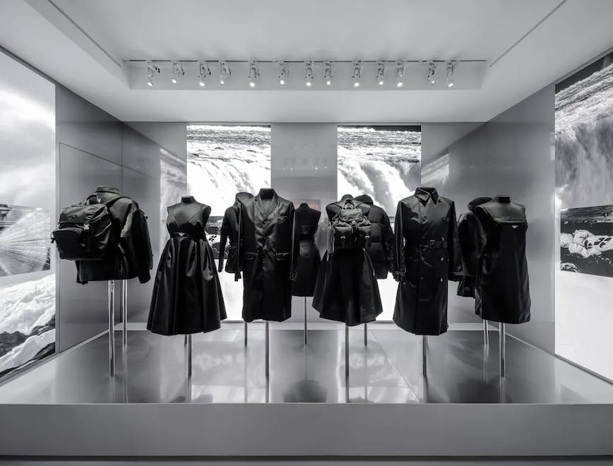black and white photo of clothes on mannequins in museum exhibit