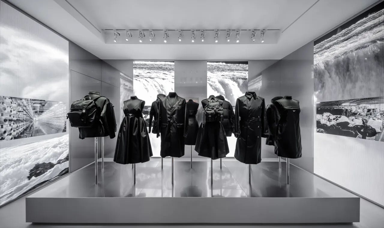 black and white photo of clothes on mannequins in museum exhibit