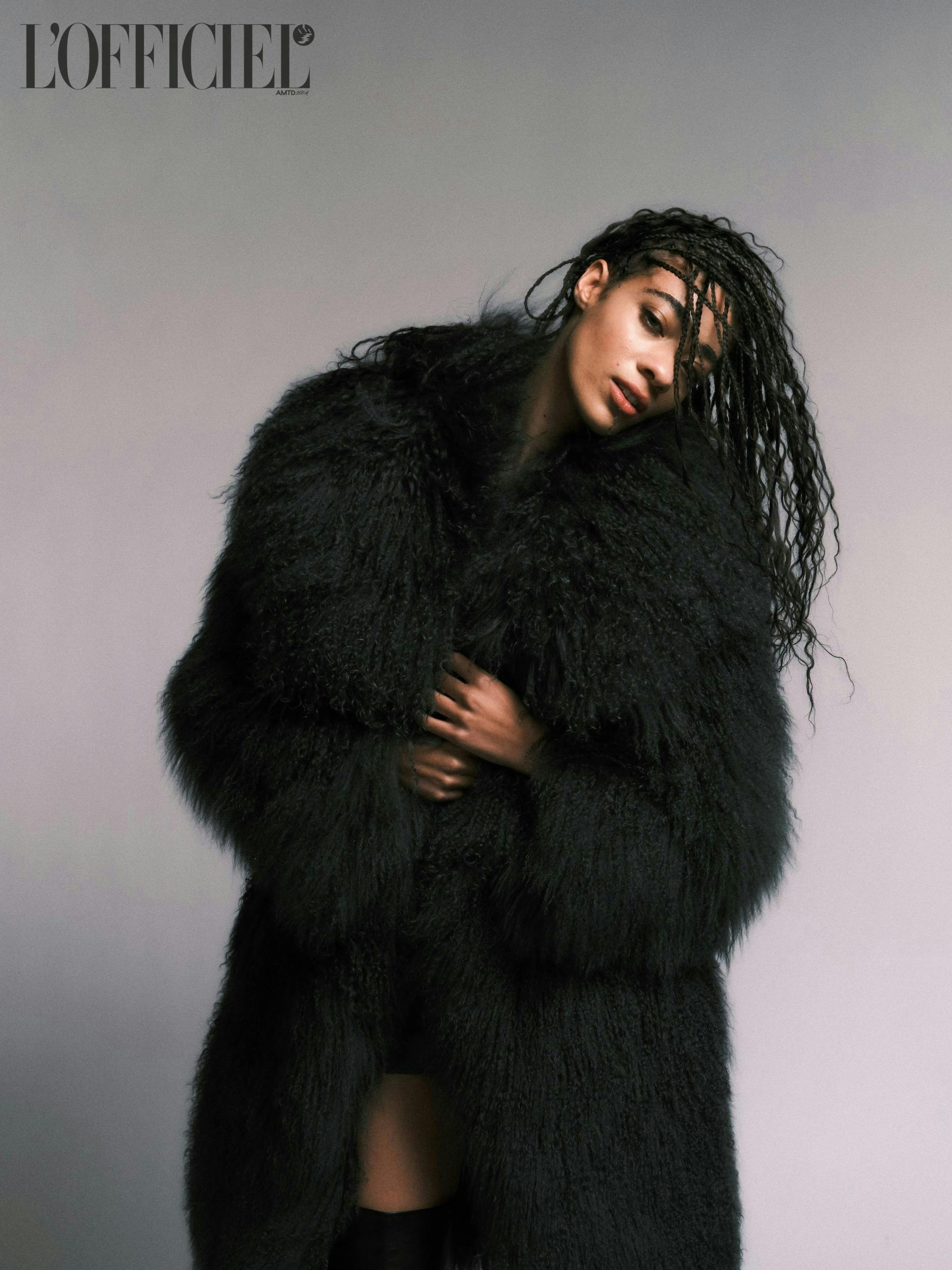 model posing wearing oversized fur coat