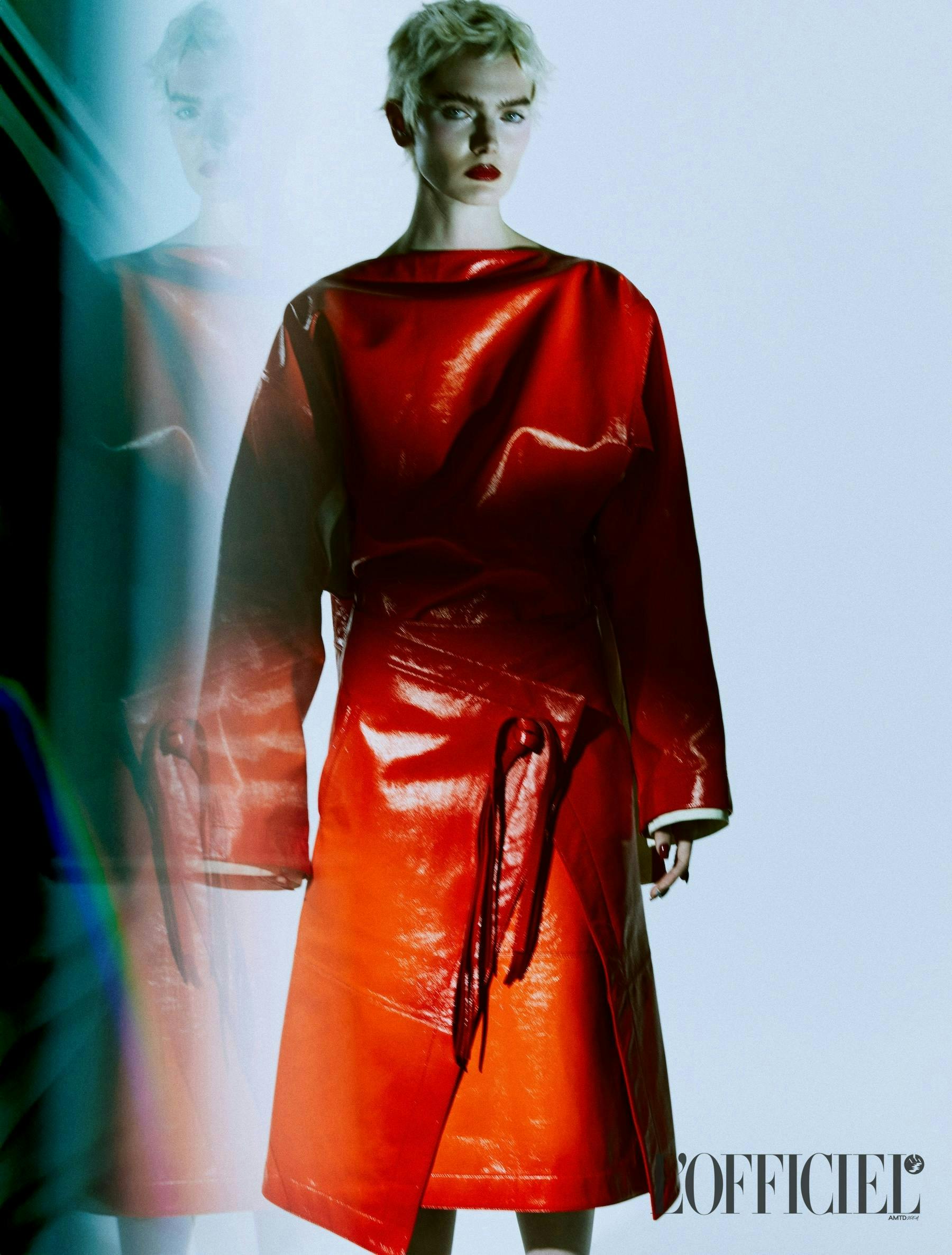 A model in an oversized red leather top and wrap skirt
