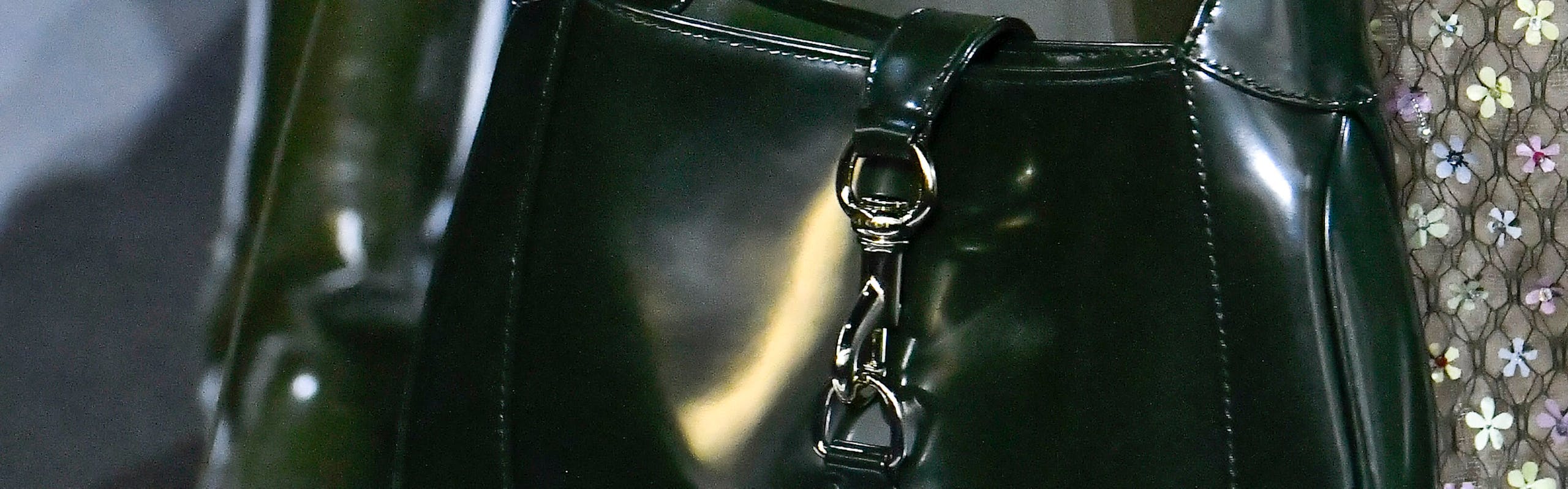olive green fall/winter 2024 color trend: closeup of accessory details on gucci fall/winter 2024; iconic gucci jackie handbag in olive green