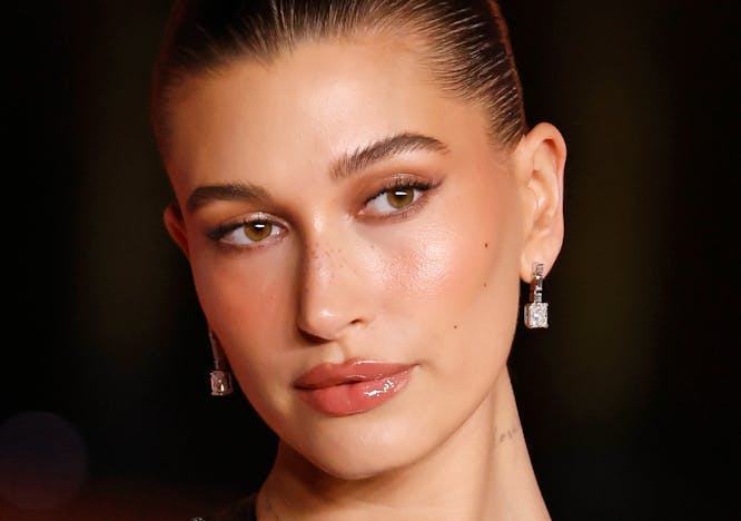 Hailey Bieber at the 2023 Academy Museum Gala wearing a shimmery black dress and silver earrings.