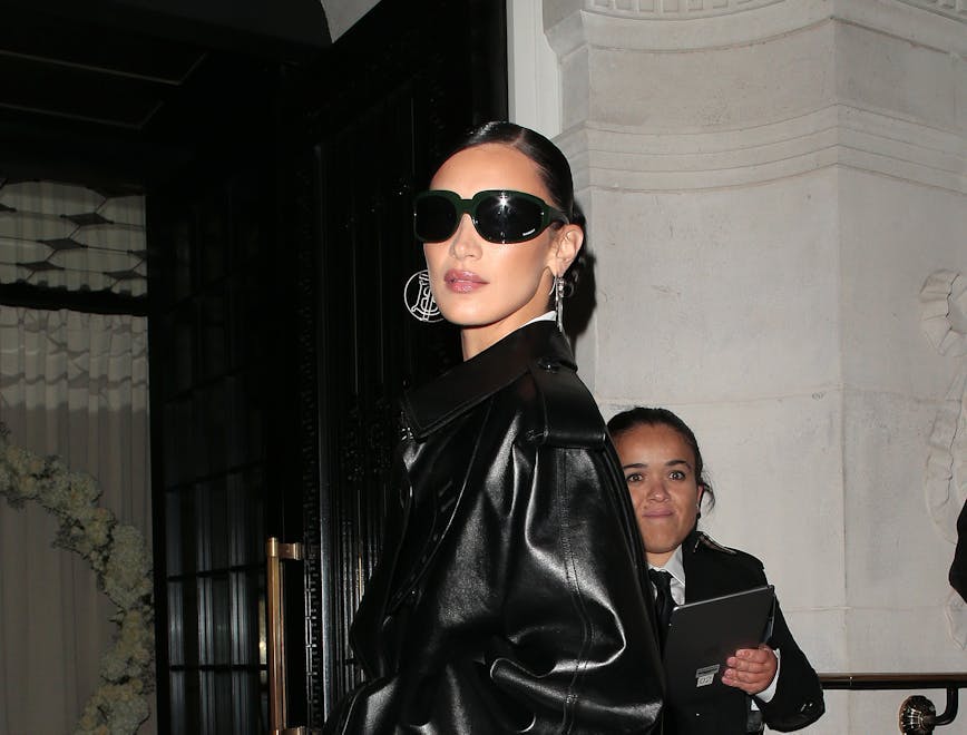 spring 2024 trench coats: bella hadid black leather trench coat